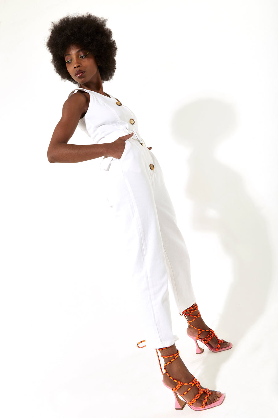 House of Holland white 90’s look denim jumpsuit with a belt and tortoise shell buttons